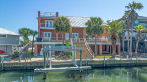 Coastal Casual Luxury! Waterfront Coastal Living on 80-feet of canal frontage with your boat in your backyard and white soft quartz beaches and Emerald waters of the Gulf of Mexico just around the corner.