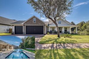Impressive Pool home in Gated Gulf Breeze community. Double 8-ft Door entrance welcomes you to spacious 4 Bedrooms, plus office/study, 3 Full Bath, 3 car garage home with many upgraded features including covered lanai with gas fireplace and mounted TV overlooking gunite saltwater pool with heated spa. Open concept has chef's dream kitchen with breakfast bar, island, gas cooktop, wine cooler, premium stainless appliances, an abundance of counter space and cabinets, drawer microwave, granite counter tops, hood vented to outside and breakfast room. Porcelain tile throughout the living area, step up ceilings