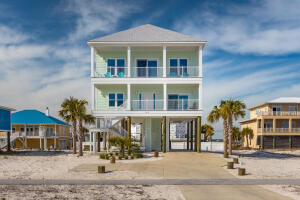 Welcome to the Beach! Coastal Furnished Beach Home with 180 mph construction has wide balconies that span the front of the home providing perfect place to enjoy Gulf breezes and embrace the views of the Gulf of Mexico.