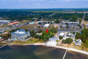 Prime High & Dry location for Development! Daily 2021 Traffic Count of 46,000. HCD Commercial Plus Waterfront R-2 with white sandy beach on the Santa Rosa Sound. 